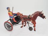a figurine of a man riding in a horse drawn carriage