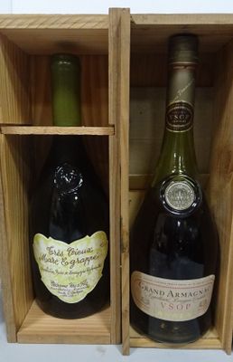 two bottles of wine sitting in a wooden box