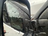 a side view mirror of a car with a broken window