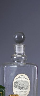 a bottle of liquor and a box of cigarettes on a table