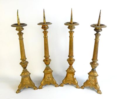 three brass candlesticks are sitting next to each other