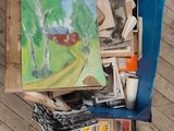 a painting in a box on the floor next to a box of stamps