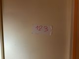 a sign that says 123 on the door of a room