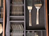 a wooden box with silverware in it on a table