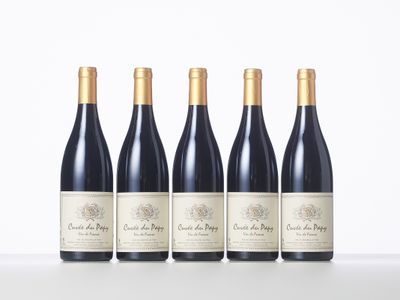 four bottles of red wine lined up in a row