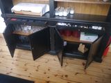 a black cabinet with a wine glass and a box on it