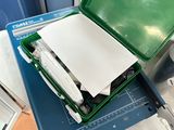 a green box that has some papers inside of it