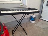 a keyboard that is sitting on a stand in front of a window