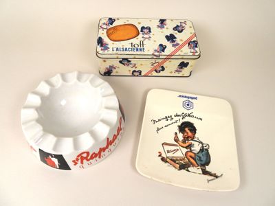 two ashtrays and a small ashtray on a table