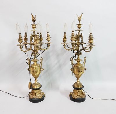 pair of antique brass candelabs with glass lamps