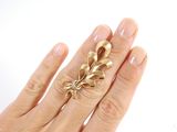 a woman ' s hand with a gold ring on it