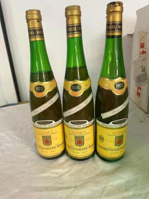 three bottles of wine sitting on top of a table next to a box