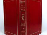 a red book that is open on a white surface