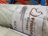 a roll of fabric sitting on the floor in a warehouse