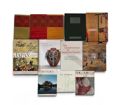 several books are stacked on top of each other on a white surface