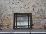 a window in the middle of a stone wall