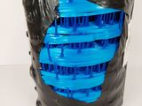a black and blue plastic mask with a hole in it