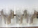 several glasses are lined up on a tray on a table