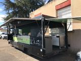 a food truck that is parked in front of a building