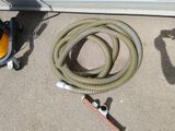 a hose that is sitting on the ground next to a hose