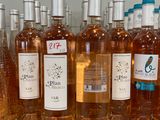 several bottles of wine are lined up on a counter
