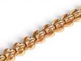 an image of a close up of a chain of gold colored beads