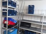 a room that has a bunch of shelves and bins in it