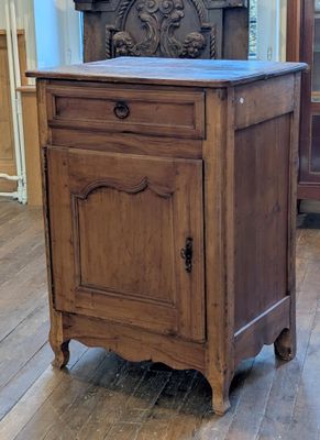 une armoire en bois avec un plateau en marbre posée sur un parquet en bois massif