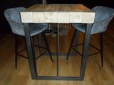 a picture of a table with two chairs and a wine glass