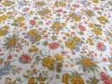 a bed with a floral comforter on top of it