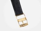 a close up of a black leather belt with a gold buckle