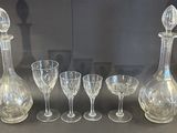 five wine glasses and a decanter on the table