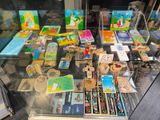 a glass display case filled with art and craft items