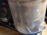 a plastic container with dirt in it sitting on a table