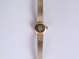 a close up of a watch on a white surface with a white background