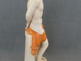 a figurine of a man sitting on top of a box