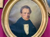 a painting of a man in a tuxedo in a gold frame
