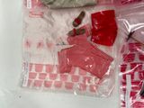a bag of clothes and a pair of scissors on a table