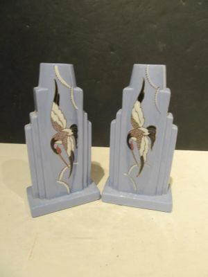 pair of blue art deco bookends with cranes on them