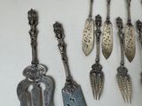 a lot of spoons that are hanging on a wall