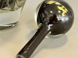 a glass of water and a black and white object