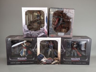 three boxes of assorted action figures sitting on top of a table
