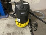 a yellow and black vacuum sitting on the floor