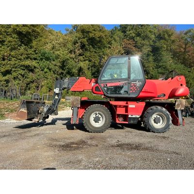 a red tractor that is parked in the dirt