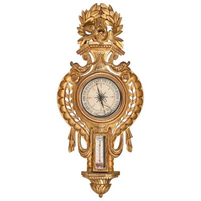 a gold clock on the wall with a clock on it