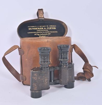 an old pair of binoculars sitting in a case on a white surface
