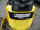 a yellow and black machine with a hose attached to it