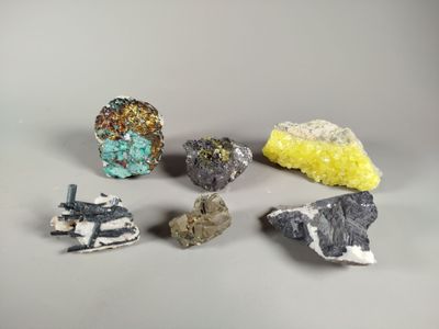 several different types of rocks and stones on a gray surface