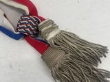 a close up of a red, white and blue tie with a knot