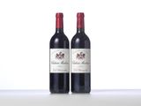 two bottles of red wine sitting next to each other on a table